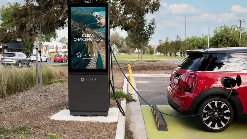 Electric vehicle charging at a public station with a digital display