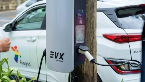 Street-side charging unit connected to a parked car