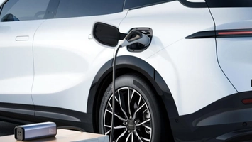 White EV plugged into a CCS2 charger demonstrating two-way charging capability.