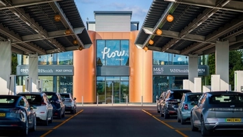 Urban ultrafast EV charging station with solar canopies and multiple vehicles