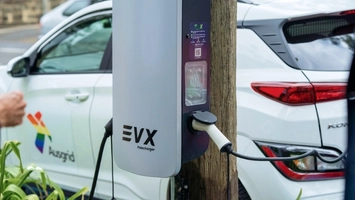 Street-side charging unit connected to a parked car