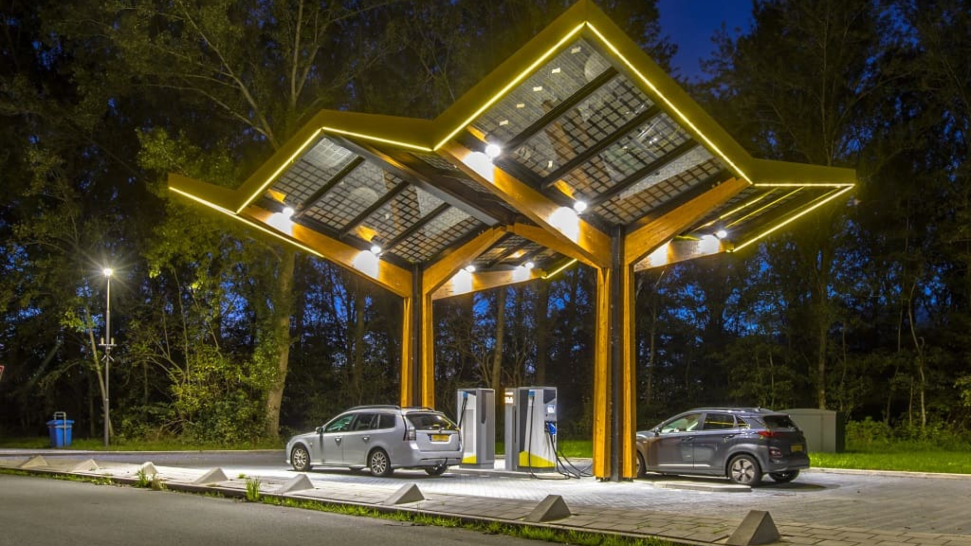 Solar powered EV charging station glowing at night in Australia