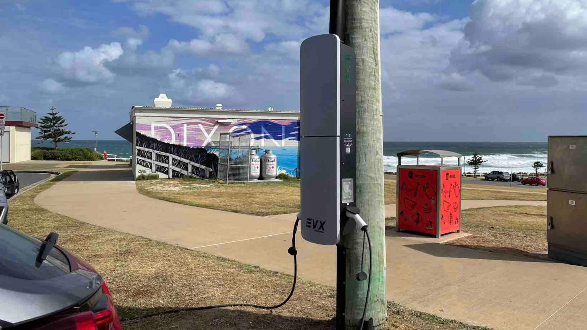 Kerbside EV charger installed on street power pole near Australian coastline